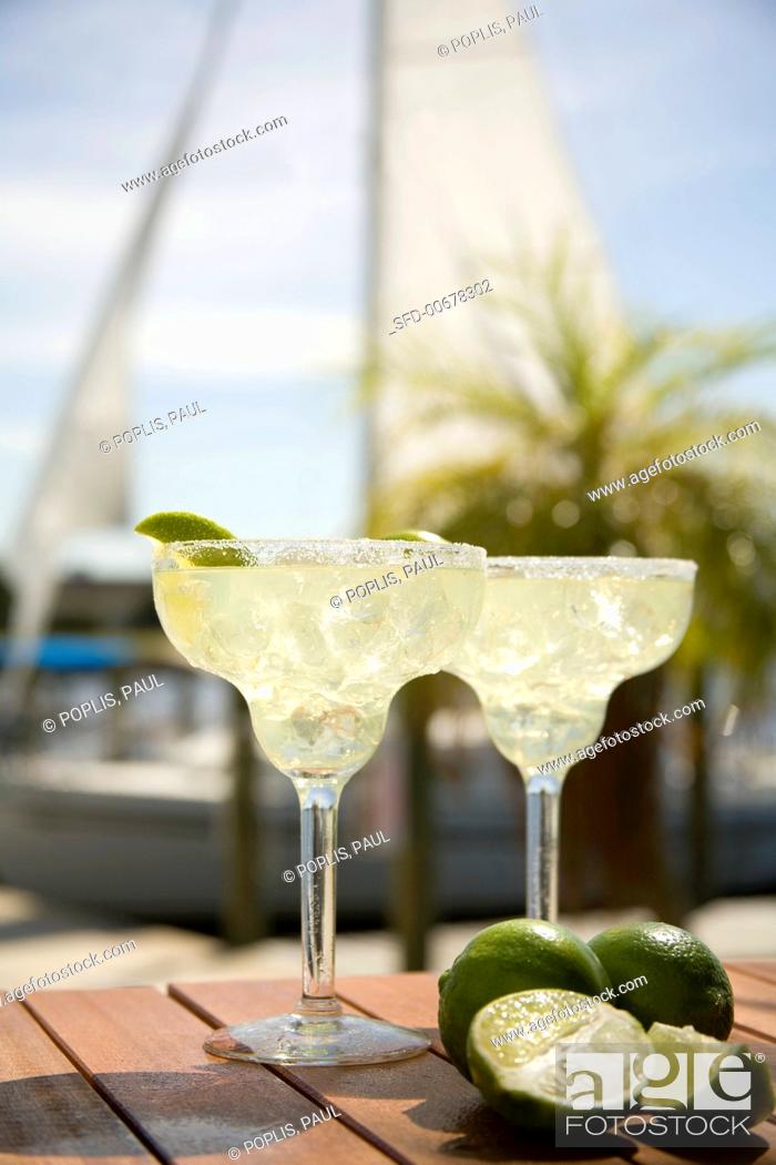Stock Photo: Margaritas on an Outdoor Table, a Sailboat in the Background.