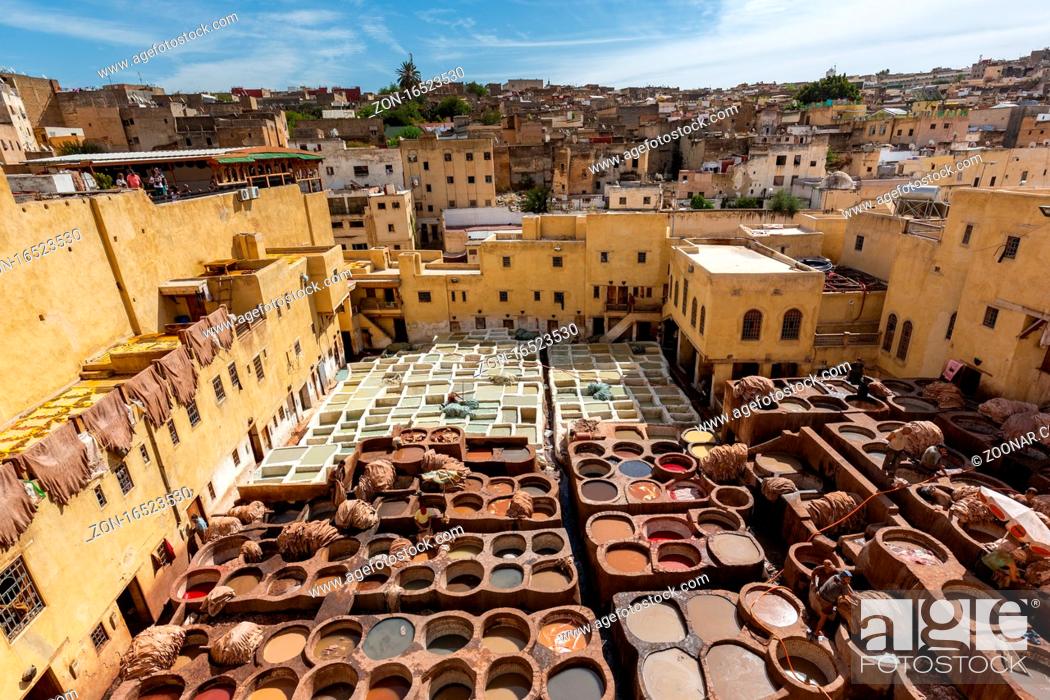 Stock Photo: Fez, Morocco-Oct. 10, 2019: Chouara Tannery in Fez city. Workers dyeing the leathers in the vats for further process.It is the oldest and most tourist.