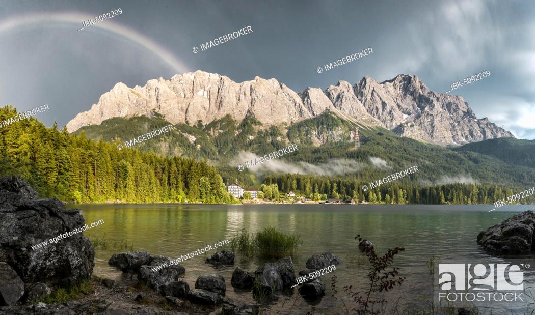 Stock Photo: Rocks on the shore, Eibsee lake in front of Zugspitze massif with Zugspitze with rainbow, Wetterstein range, near Grainau, Upper Bavaria, Bavaria, Germany.