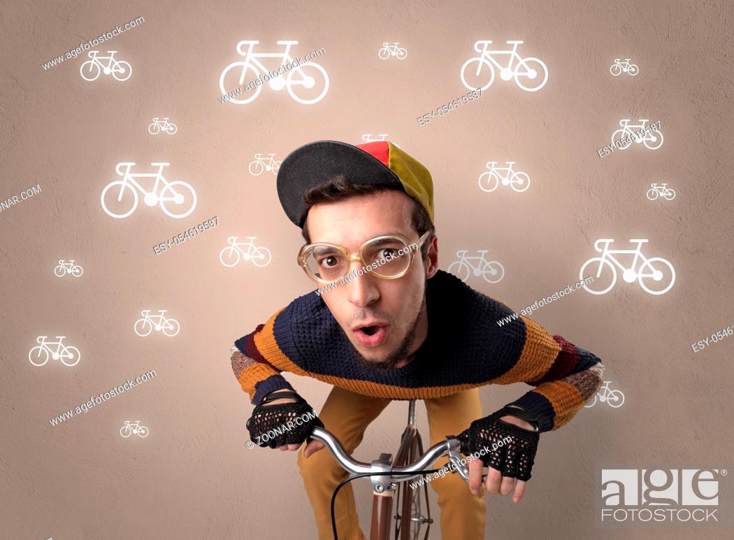 Stock Photo: Young ridiculous biker with line drawn bikes on the background.