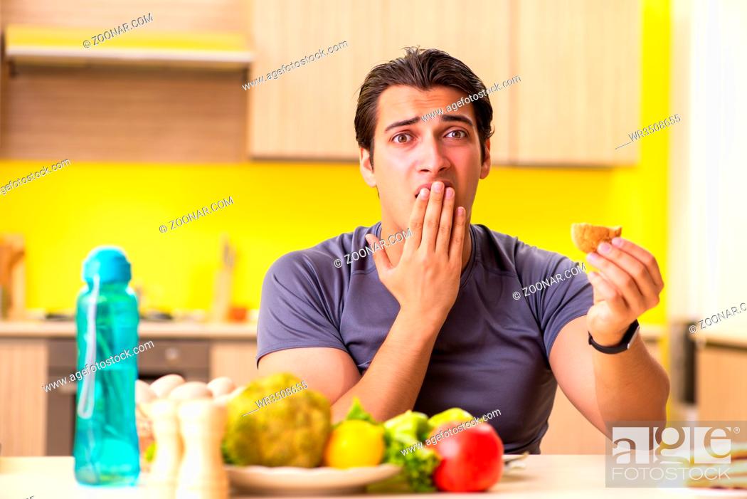 Stock Photo: Man having hard choice between healthy and unhealthy food.