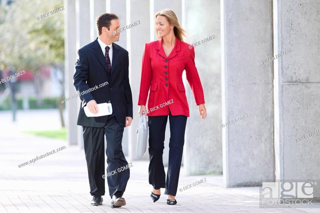 Stock Photo: Businesspeople walking together outdoors.