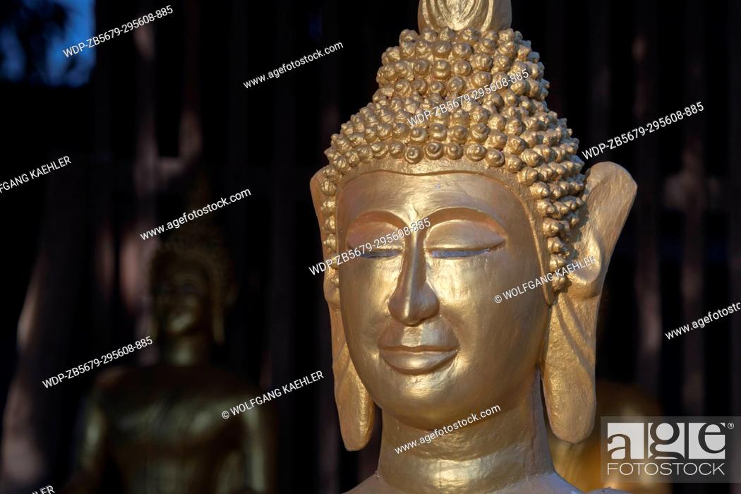 Stock Photo: Detail of a guilded Buddha statue at Wat Xieng Muan (Xieng Muan Vajiramangalaram) a Buddhist temple in the UNESCO world heritage town of Luang Prabang in.