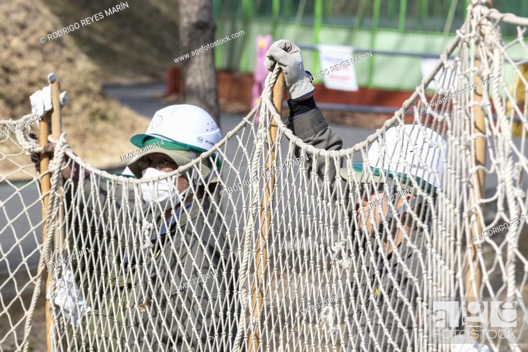 Stock Photo: February 22, 2019, Tokyo, Japan - Zookeepers hold up a net during an Escaped Animal Drill at Tama Zoological Park. The annual escape drill is held to train.