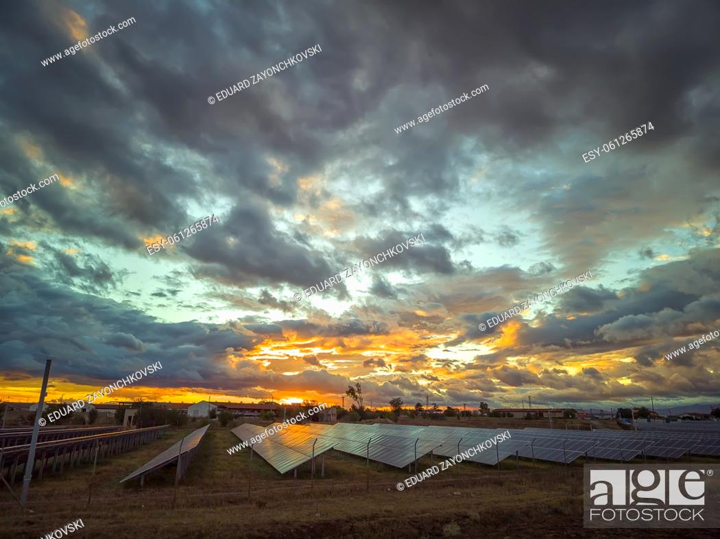 Stock Photo: Stunning colorful sky after sunset over solar panels.