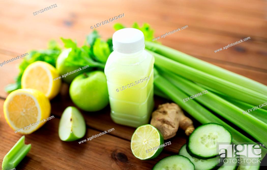 Stock Photo: healthy eating, food, dieting and vegetarian concept - bottle with green juice, fruits and vegetables on wooden table.