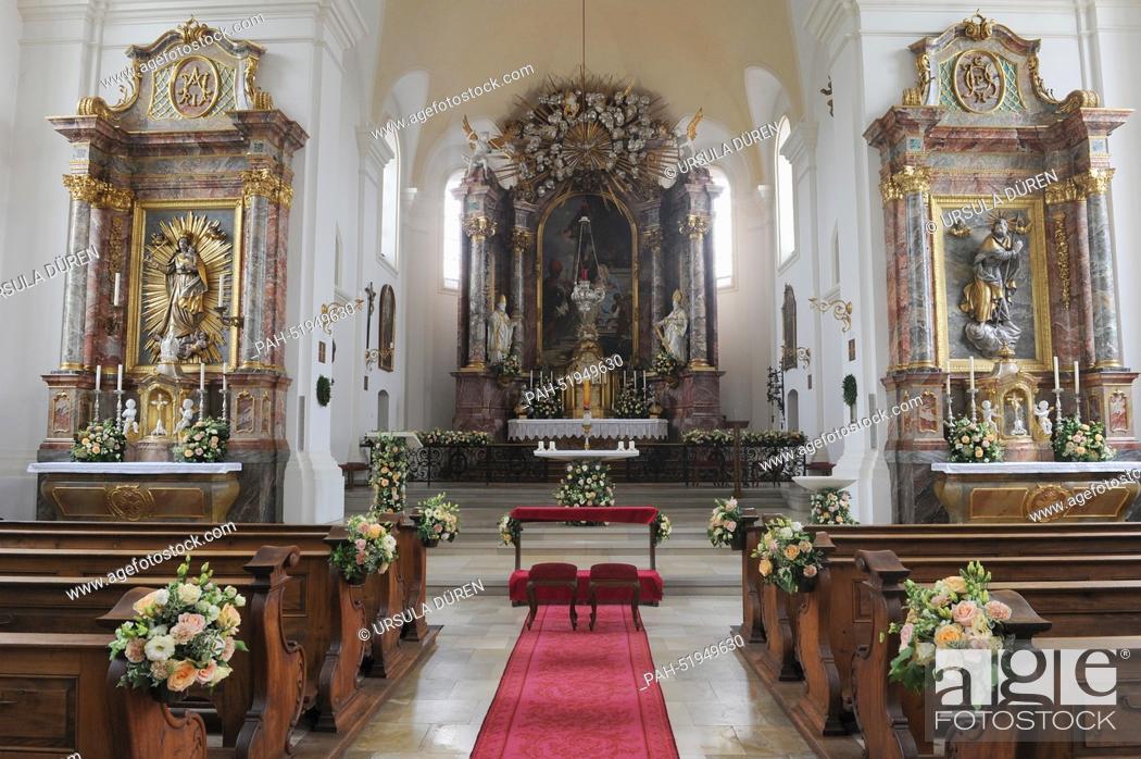 Stock Photo: Flowers decorate the central nave and the altar in the church of Saint Joseph prior to the wedding of Maria Theresia von Thurn and Taxis and Hugo Wilson in.