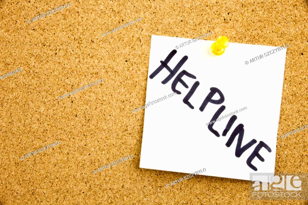 Stock Photo: Phrase HELP LINE HELP LINE in black ext on a sticky note pinned to a cork notice board.