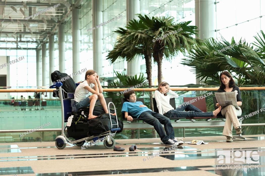 Stock Photo: Family waiting in airport terminal.