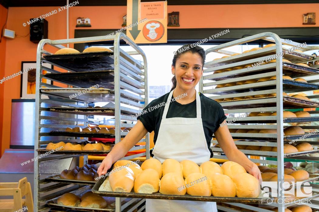 Stock Photo: Hispanic baker working in commercial kitchen.