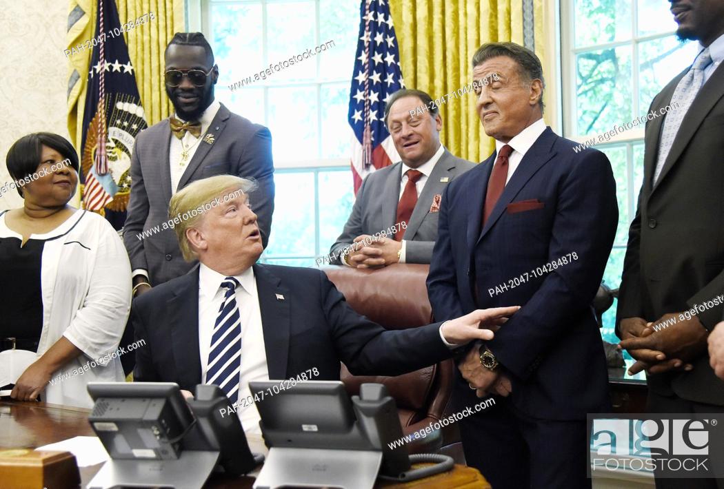 Stock Photo: United States President Donald J. Trump acknowledges actor Sylvester Stallone after signing an Executive Grant of Clemency for former heavyweight champion Jack.