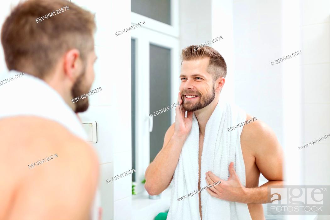 Morning Hygiene Handsome Man In The Bathroom Looking In Mirror