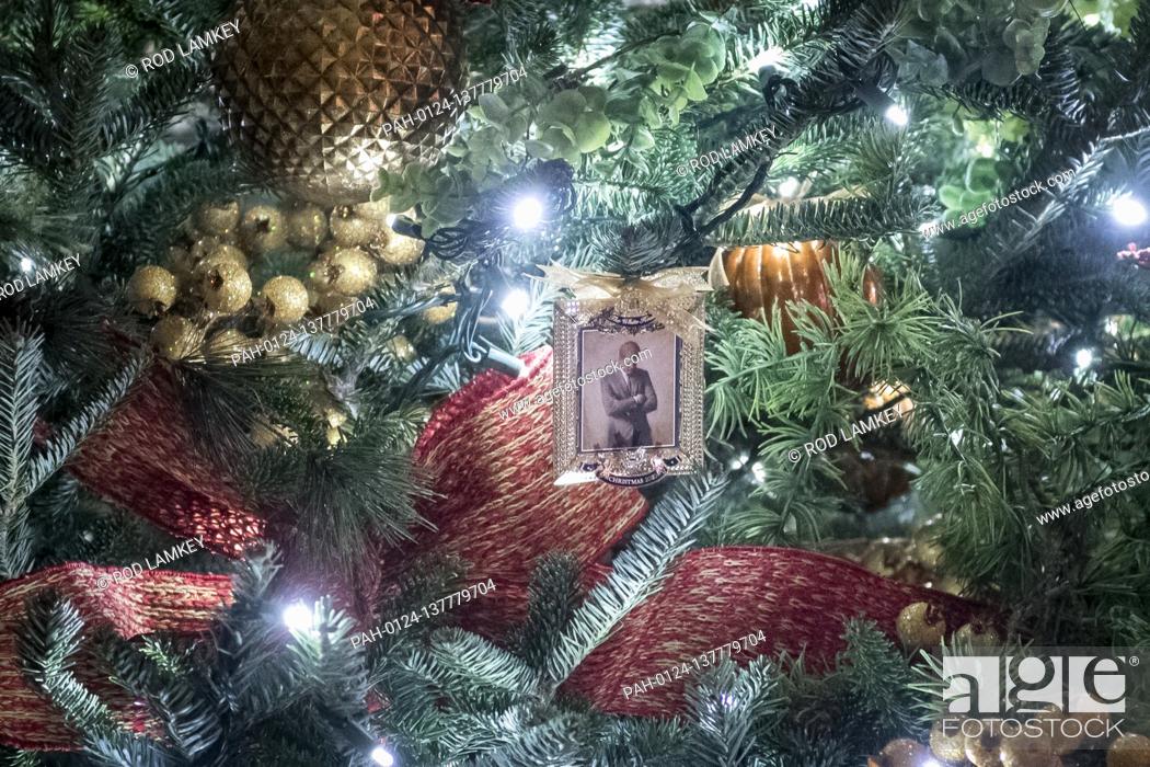 Stock Photo: A depiction of US President John F. Kennedy’s official portrait is featured on ornaments hanging from a tree in The Vermeil Room of the White House during the.