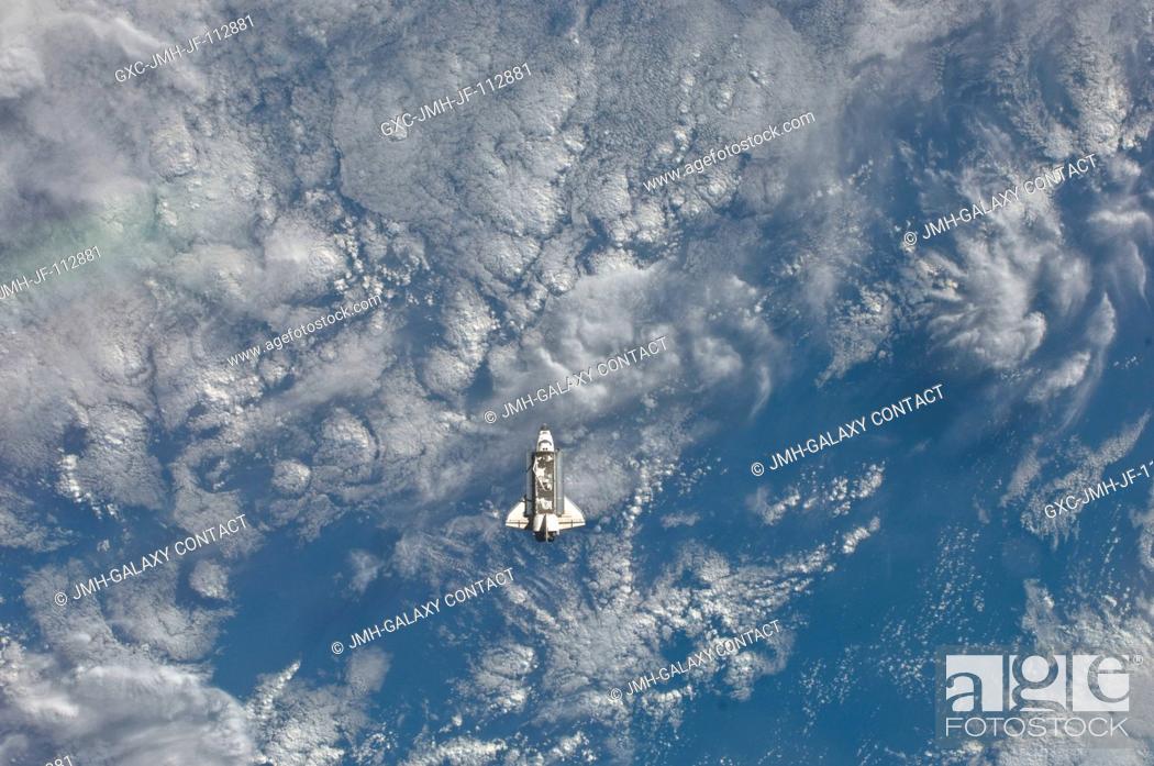 Stock Photo: One of the Expedition 27 crew members aboard the International Space Station (ISS) recorded this image of the distant space shuttle Endeavour.