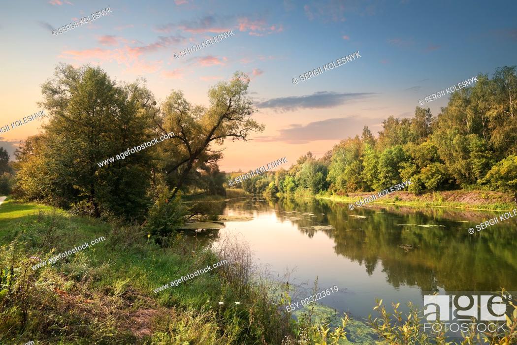 Stock Photo: Pink sunset over river in the forest.