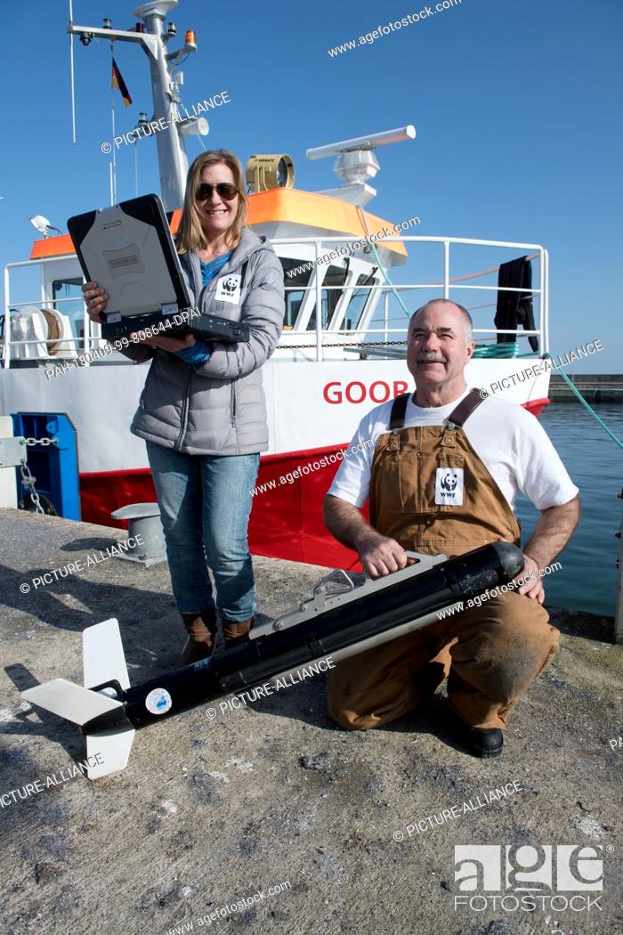 Stock Photo: 08 April 2018, Germany, Sassnitz: Carayton Fenn and Terri Fenn, sonar experts from the US, help test a Marine Sonic Sonar in the Baltic Sea which is designed to.