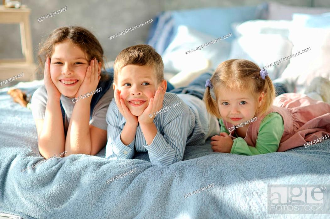 Two sisters and a brother. Three children from the same family are lying on  the bed, Stock Photo, Picture And Low Budget Royalty Free Image. Pic.  ESY-042941407 | agefotostock