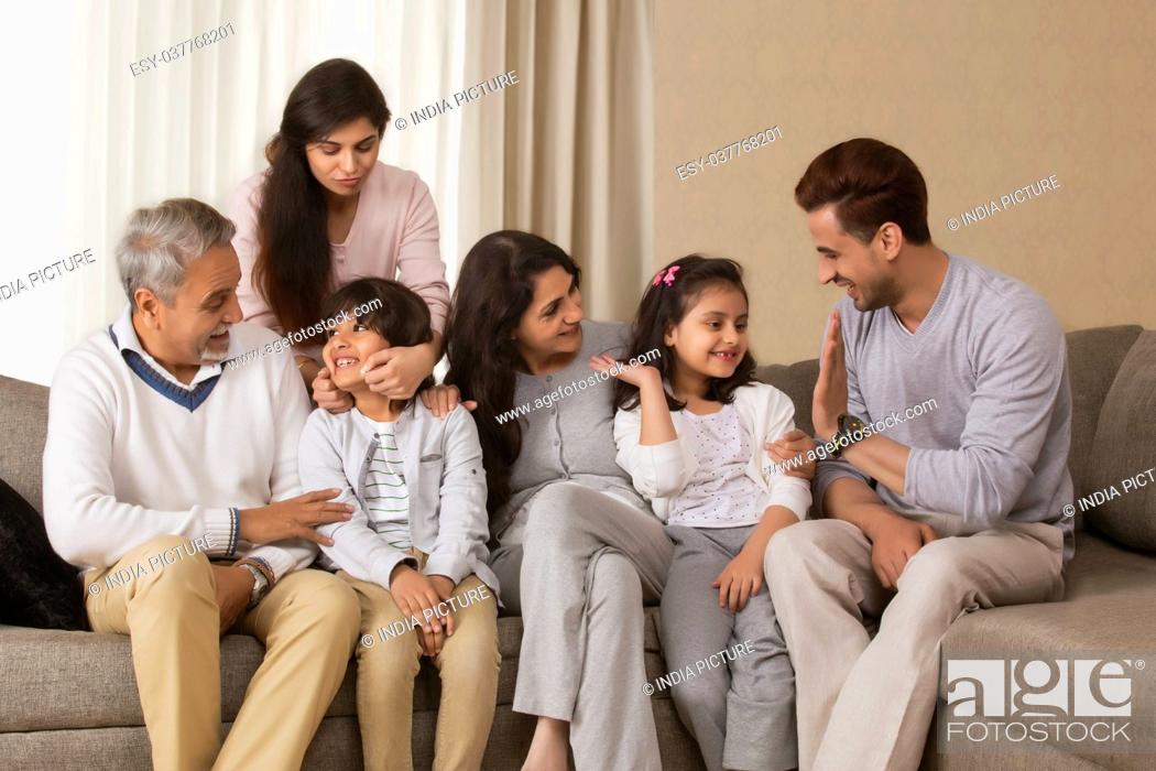 Photo de stock: Happy multi-generation family sitting on sofa.