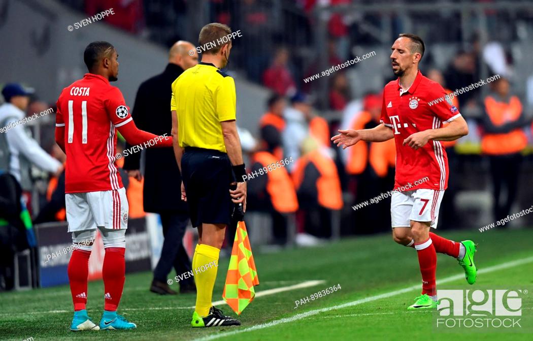 Stock Photo: Munich's Franck Ribery (r) is exchanged for Douglas Costa (l) during the first leg of the Champions League quarter final match between Bayern Munich and Real.