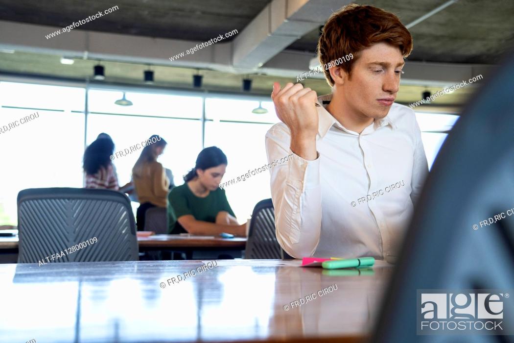 Stock Photo: Young man working in office.