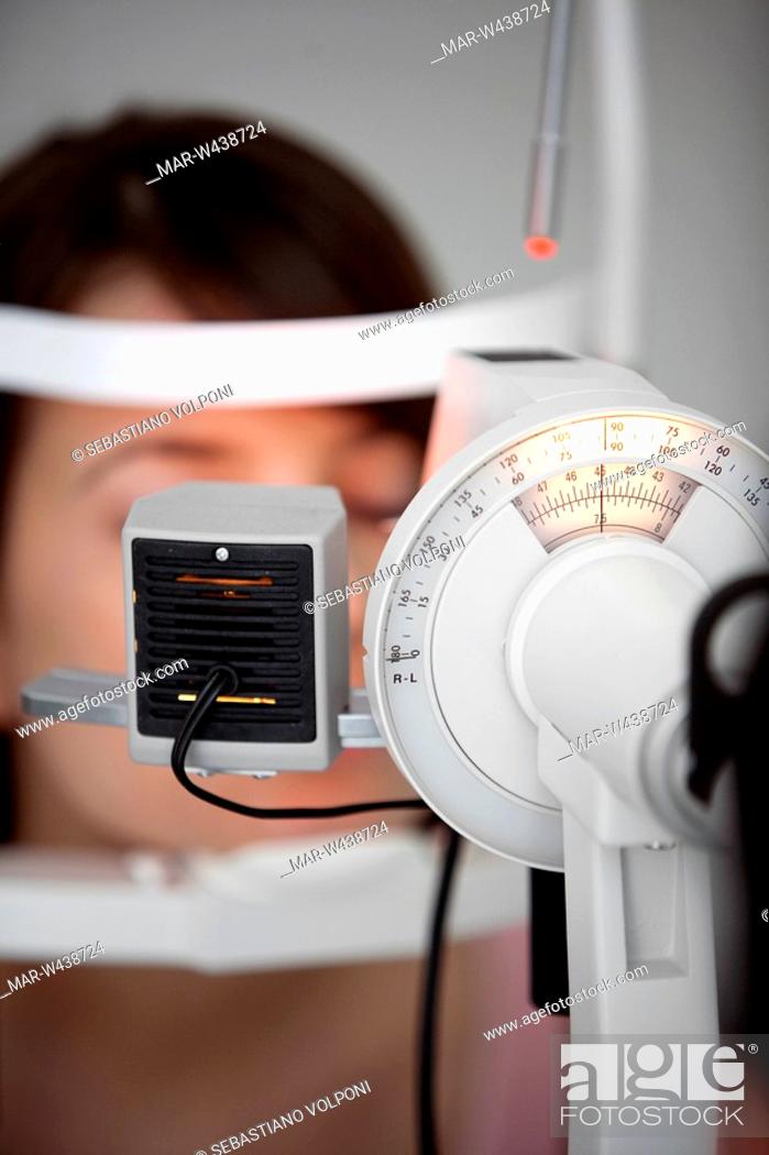 Stock Photo: young woman having her eye's tested.