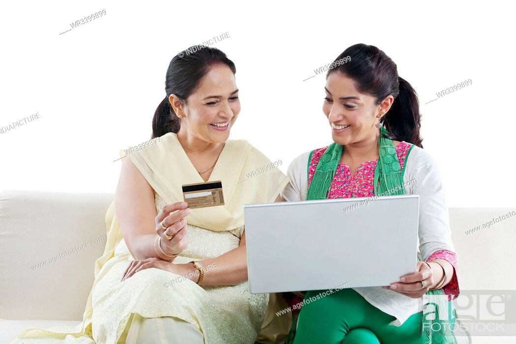 Stock Photo: Mother and daughter with a laptop and credit card.