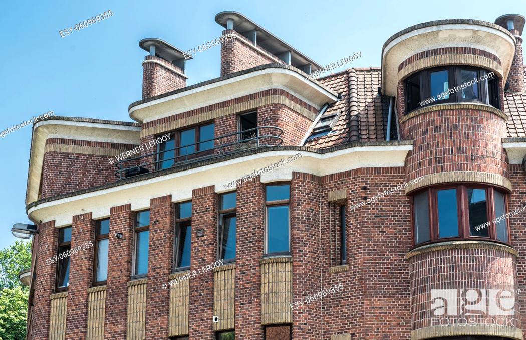 Stock Photo: Anderlecht, Brussels - Belgium Brick stone shaped facade of a residential apartment in modernist style.