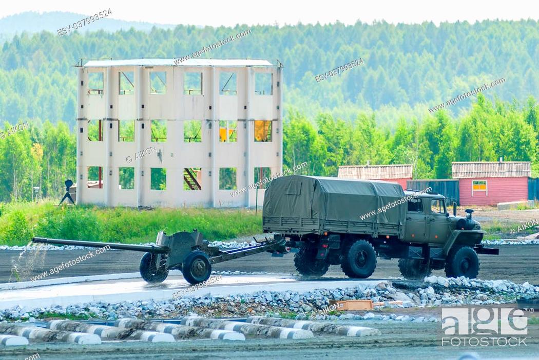 Stock Photo: Nizhniy Tagil, Russia - July 12. 2008: army truck with cannon moving after water ford. Russia Arms Expo.