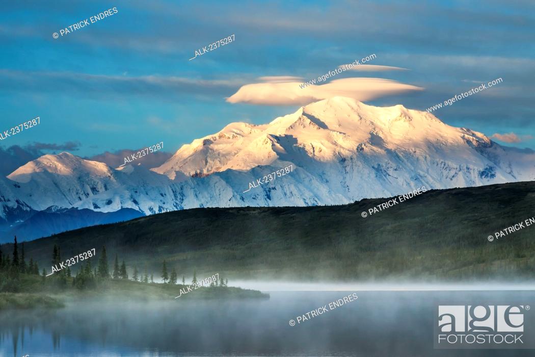 Stock Photo: Early morning sunrise on the face of Mt McKinley, locally called Denali, and Wonder Lake, at the west end of Denali National Park, interior, Alaska.