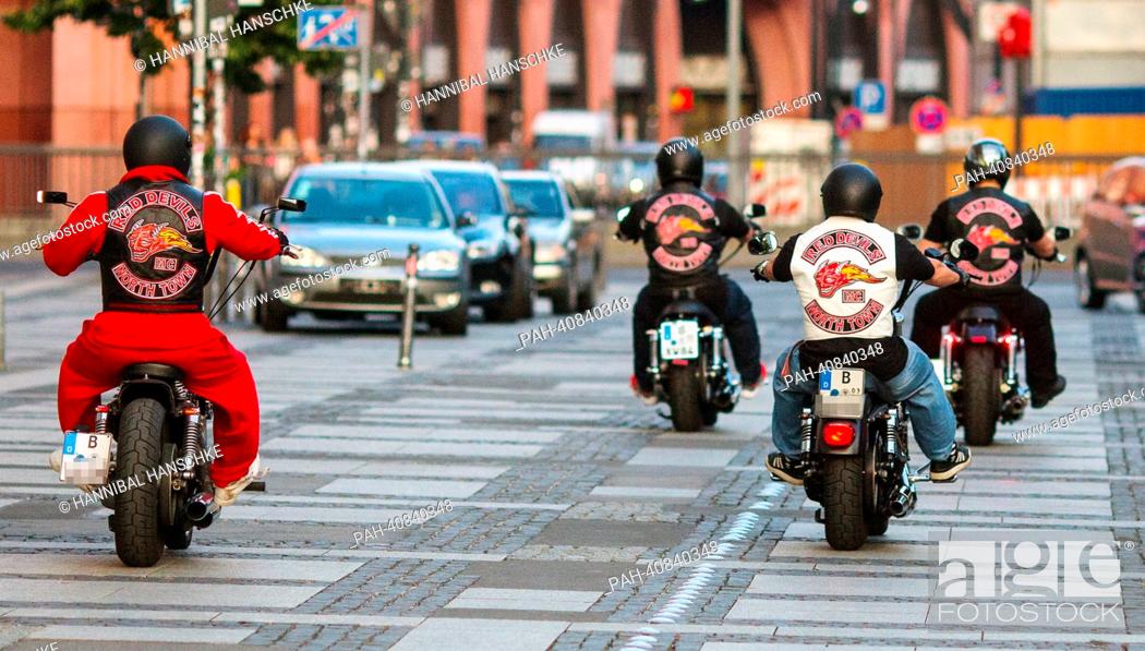 Stock Photo: Bikers of biker club 'Red Devils' drive their motorcycles on Alexanderplatz in Berlin, Germany, 02 July 2013. The 'Red Devils' are considered supporters of.