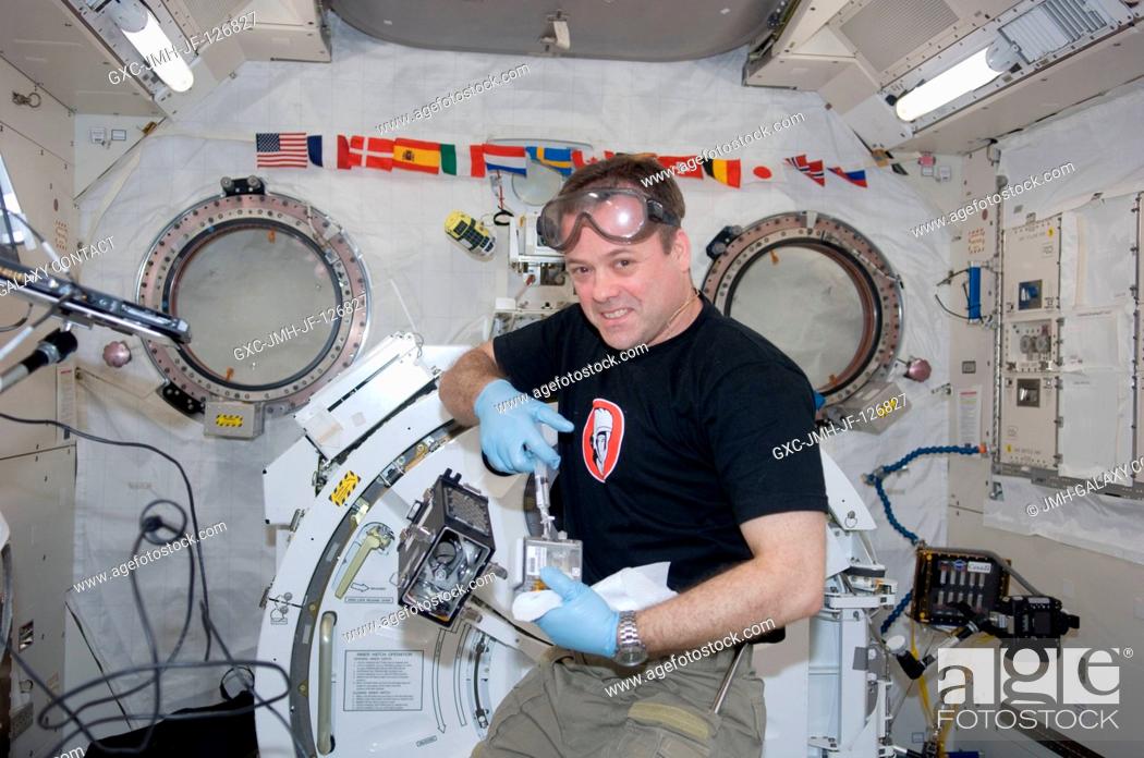 Stock Photo: NASA astronaut Ron Garan, Expedition 27 flight engineer, supports the Dynamism of Auxin Efflux Facilitators responsible for Gravity-regulated Growth and.