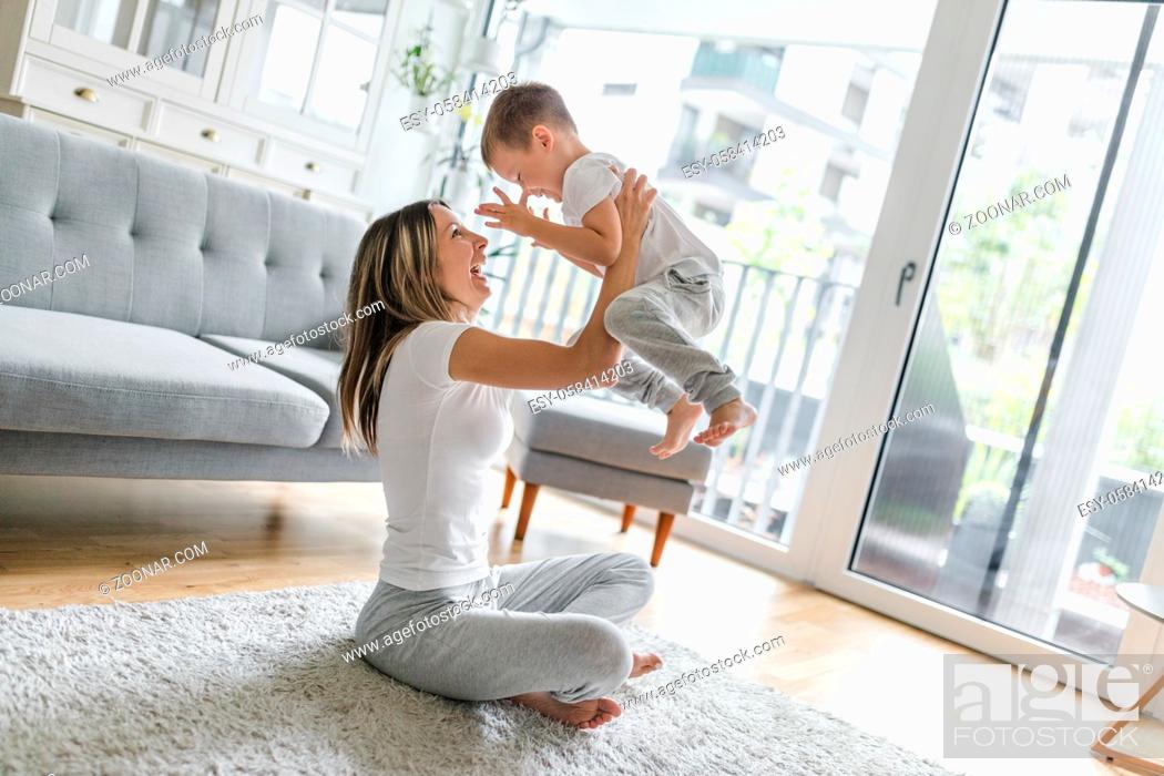 Stock Photo: Mother with her son playing in their living room.