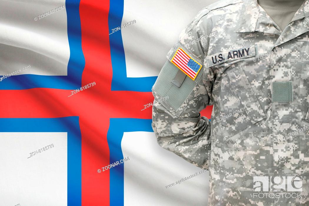 Stock Photo: American soldier with flag on background - Faroe Islands.