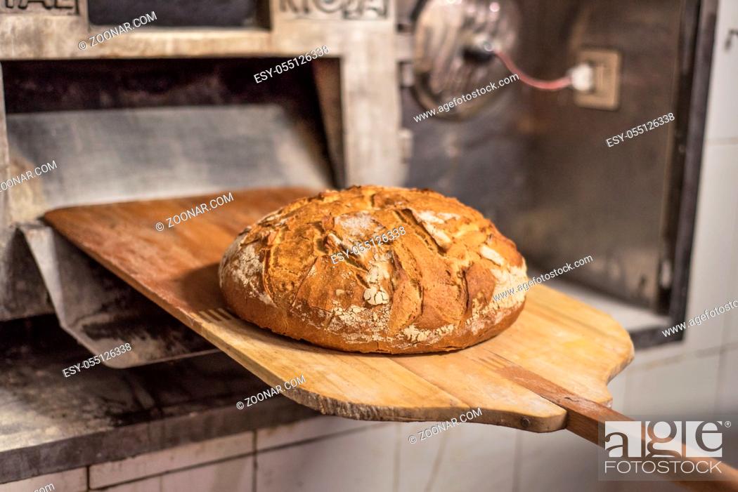 Stock Photo: Baking bread in shovel at the bakery.