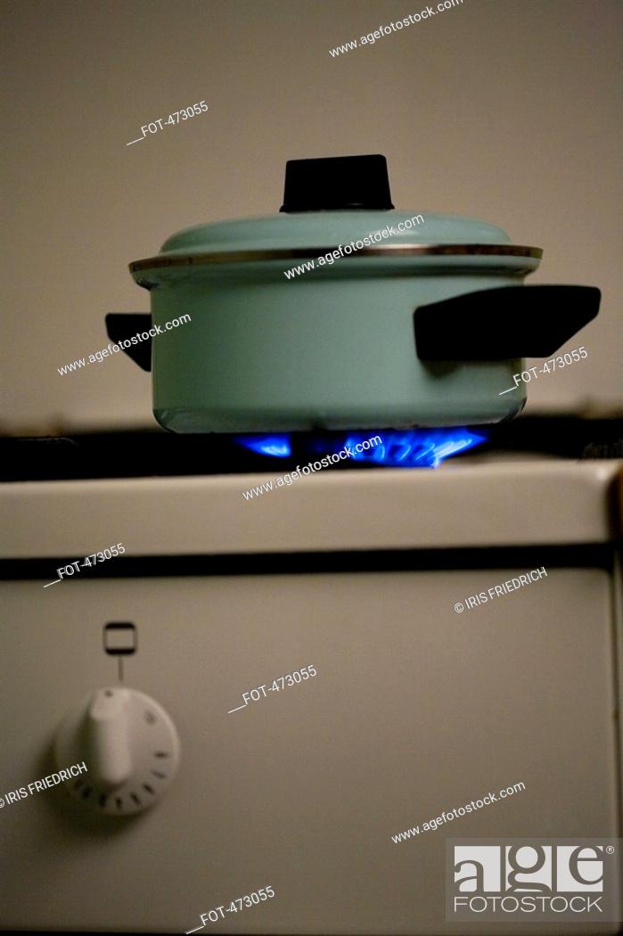 Stock Photo: A saucepan on a lit stove.