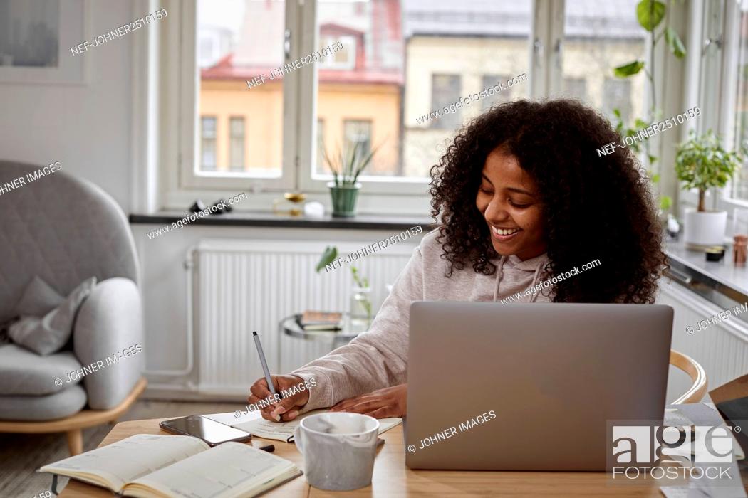 Stock Photo: Woman working from home.