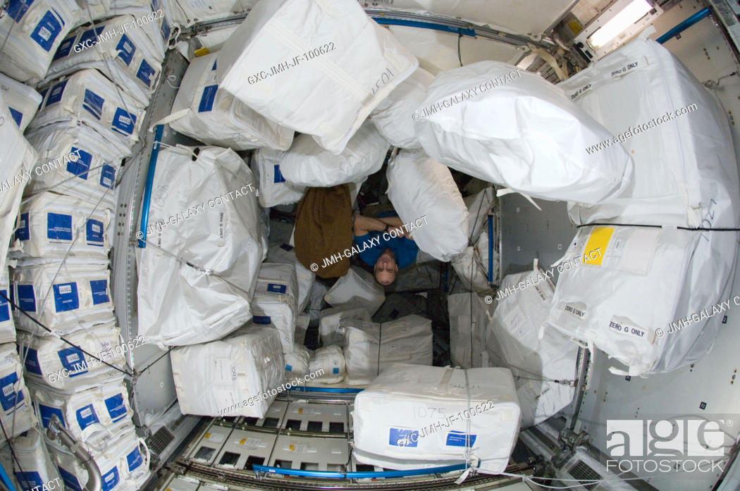Stock Photo: NASA astronaut Don Pettit, Expedition 30 flight engineer, works among storage containers in the Leonardo Permanent Multipurpose Module (PMM) of the.