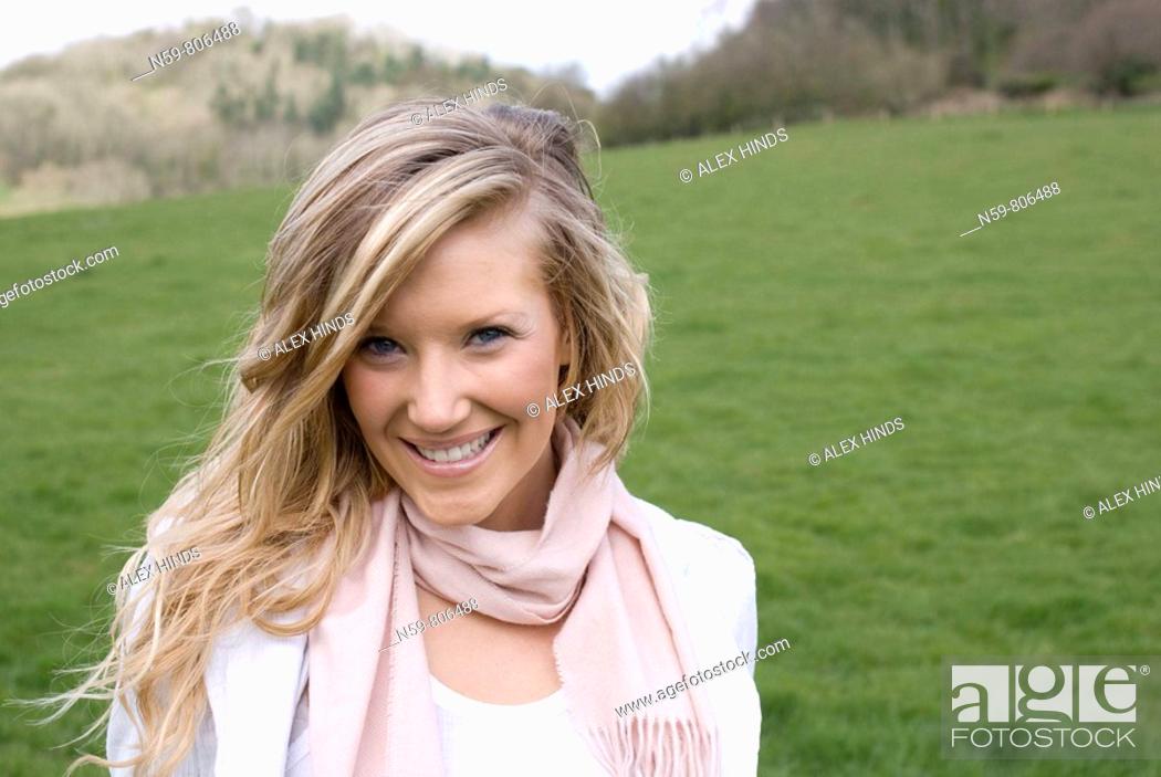 Stock Photo: Beautiful young woman enjoying being outside in a green natural environment.