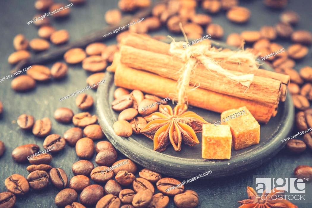 Stock Photo: Roasted coffee beans background. Coffee beans with copy space for text. Seasoning. Spice. Cinnamon. Badian. Vanilla.