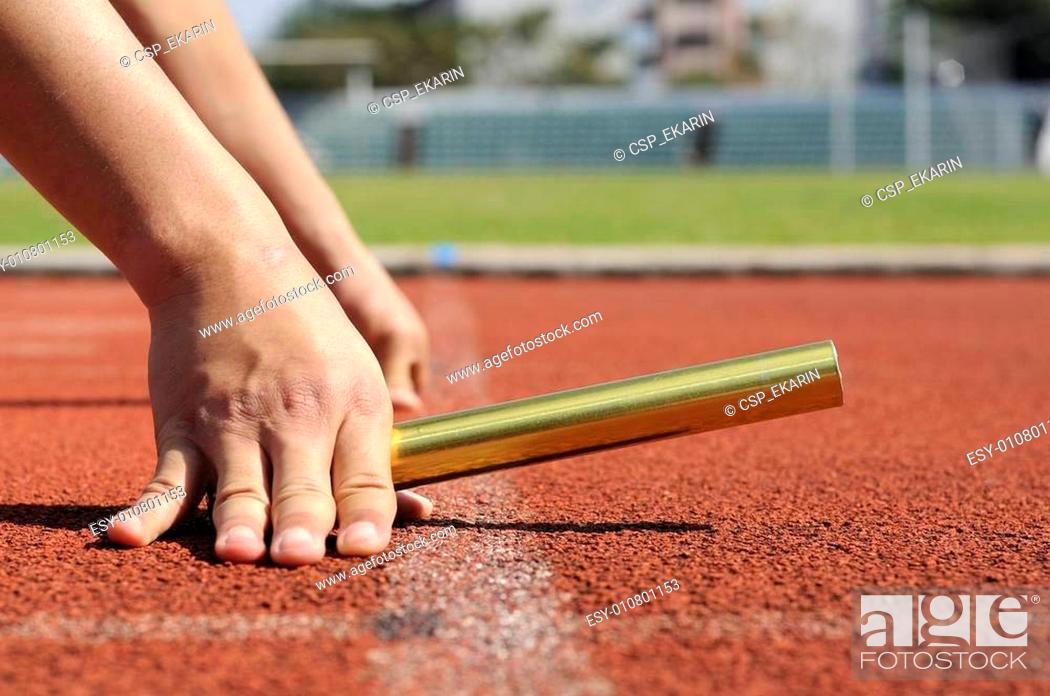 Stock Photo: Relay-athletes hands starting action.