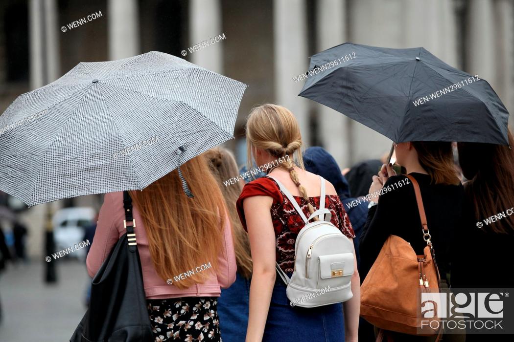 Stock Photo: People in heavy rain and windy conditions in Trafalgar Square, London Featuring: Atmosphere Where: London, United Kingdom When: 29 Sep 2016 Credit: WENN.