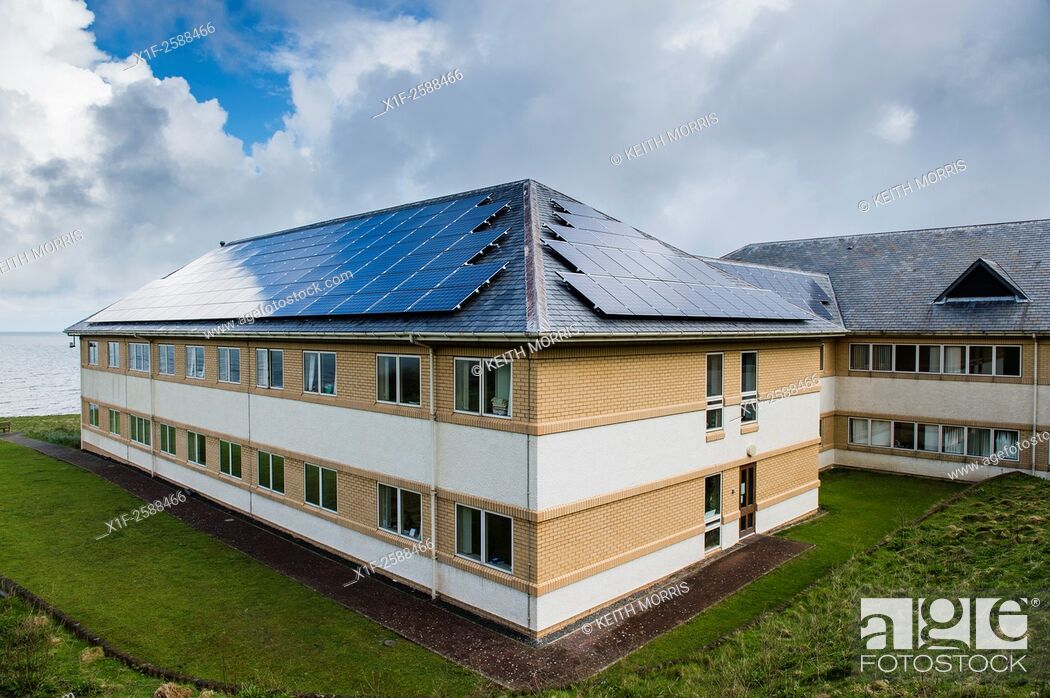 Stock Photo: Solar panels installed in contravention of their own planning rules and guidelnes on the roof of the headquarters of Ceredigion County Council.