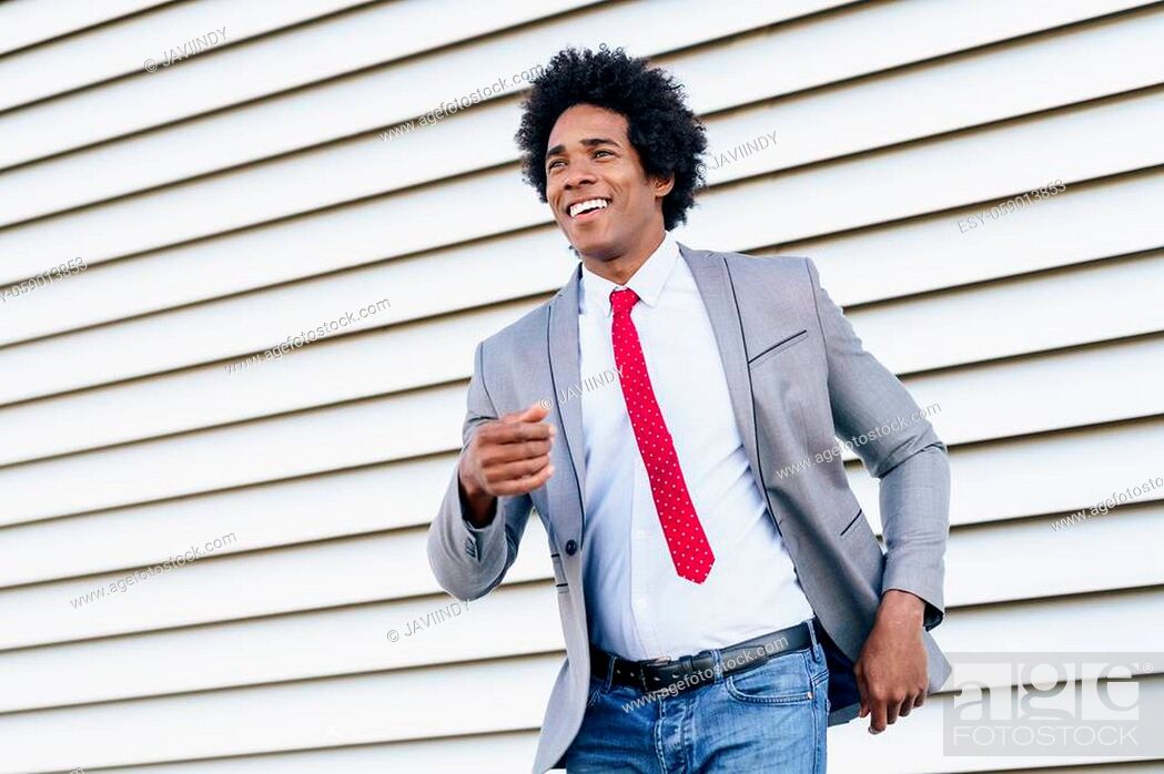 Happy Black Businessman wearing suit dancing outdoors. Man with afro hair,  Stock Photo, Picture And Low Budget Royalty Free Image. Pic. ESY-059013853  | agefotostock