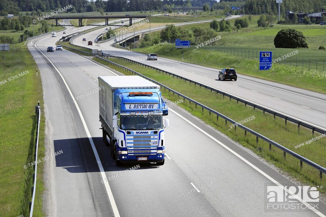 Stock Photo: Salo, Finland. June 15, 2019. Blue-white Scania 164G L Retva Oy pulls trailer along European Route E18 in South of Finland on a sunny day of summer.