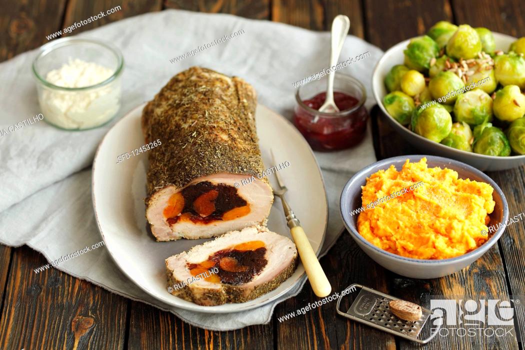 Stock Photo: Baked pork loin stuffed with prunes and dried apritots, brussel sprouts, sweet potatoes pure.