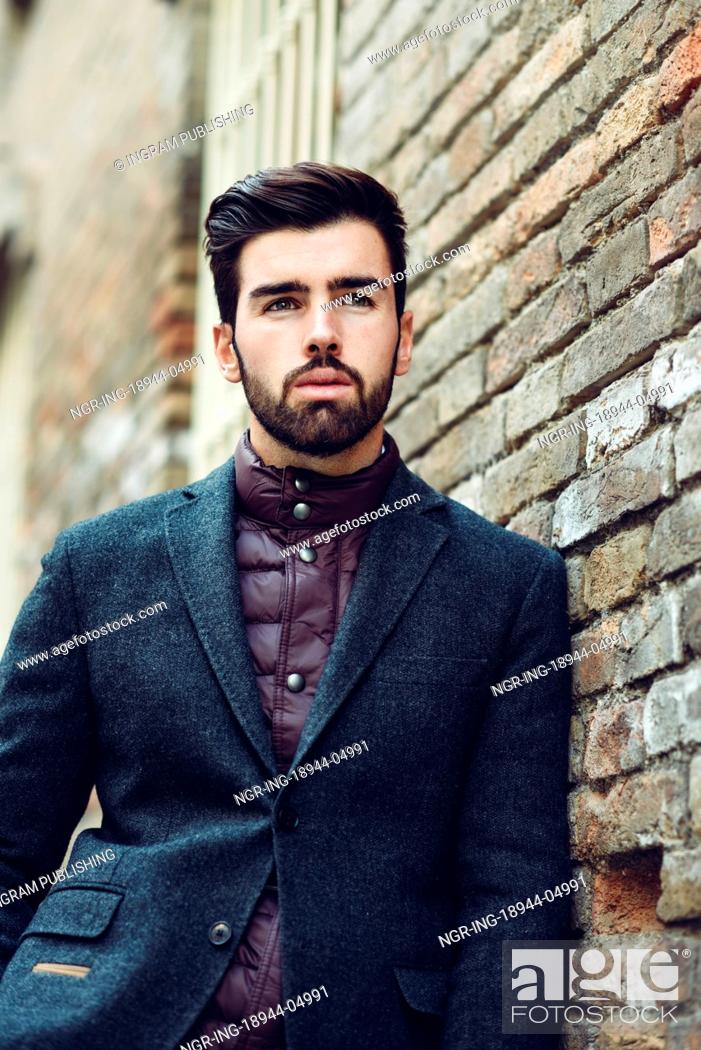 Young bearded man, model of fashion, standing in urban background wearing  british elegant suit, Stock Photo, Picture And Royalty Free Image. Pic.  NGR-ING-18944-04991 | agefotostock