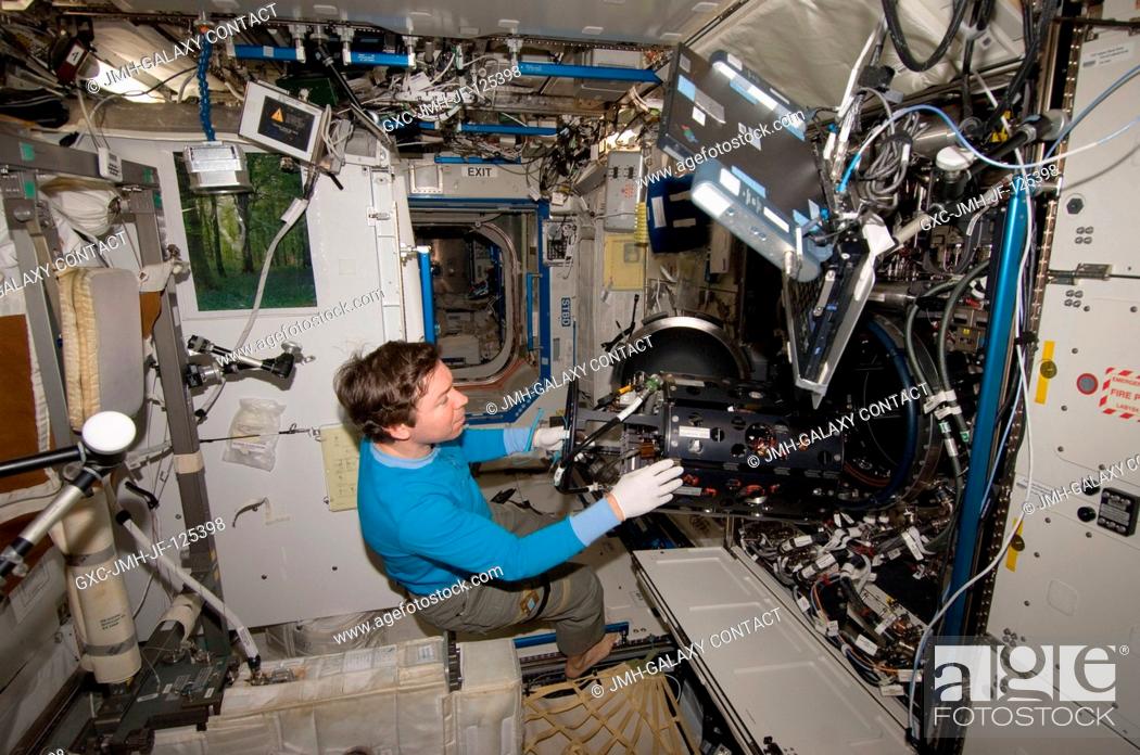 Stock Photo: NASA astronaut Michael Barratt, Expedition 20 flight engineer, works with the Multi-user Droplet Combustion Apparatus Chamber Insert Assembly (MDCA CIA) in the.