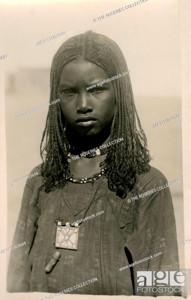 Beautiful portrait photograph of a Bisharin Girl with braided hair, beads  and long tunic - Egypt, Stock Photo, Picture And Rights Managed Image. Pic.  MEV-11063644 | agefotostock