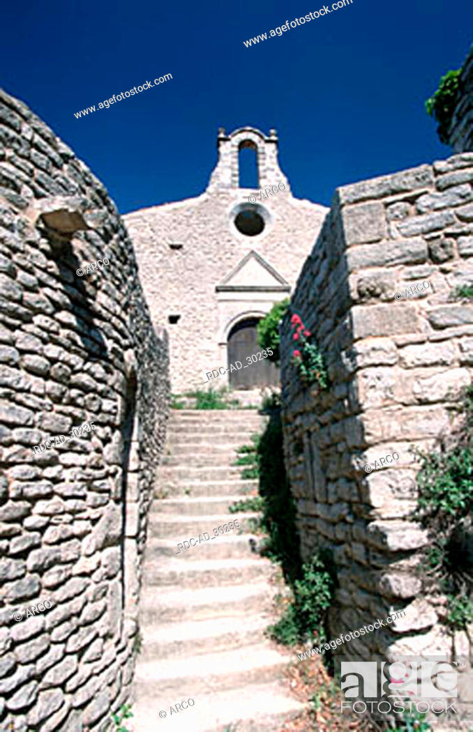 Stock Photo: Old Church and stone walls Saignon near Apt Provence Southern France.