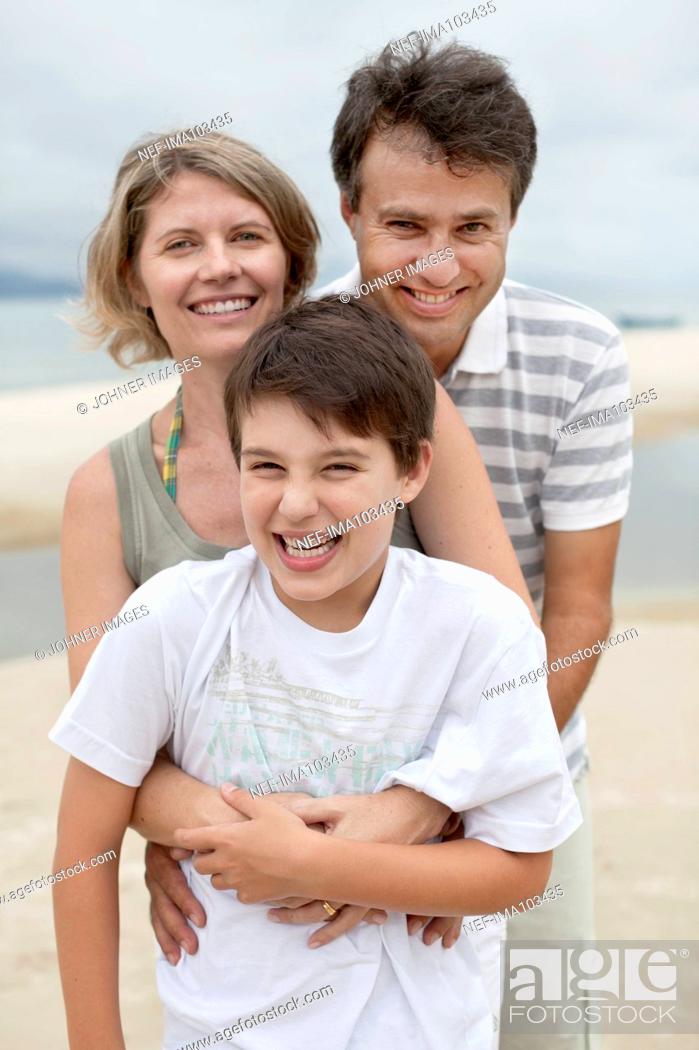 Stock Photo: Parents with son on beach.